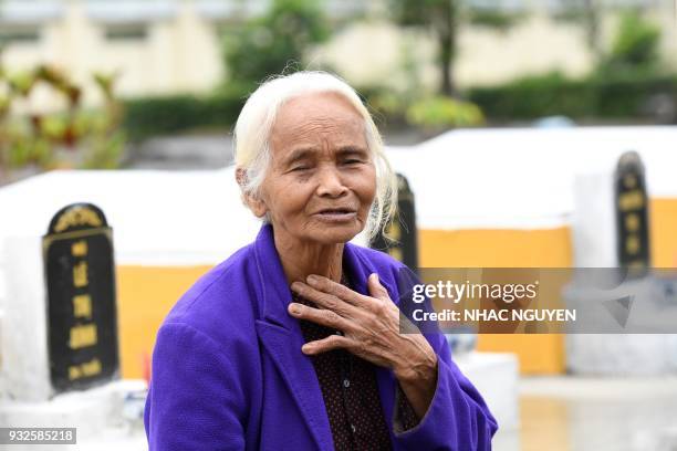 Pham Thi Thuan a survivor of the My Lai massacre, gestures while visiting the mass grave in Son My village in Quang Ngai province on March 15, 2018....