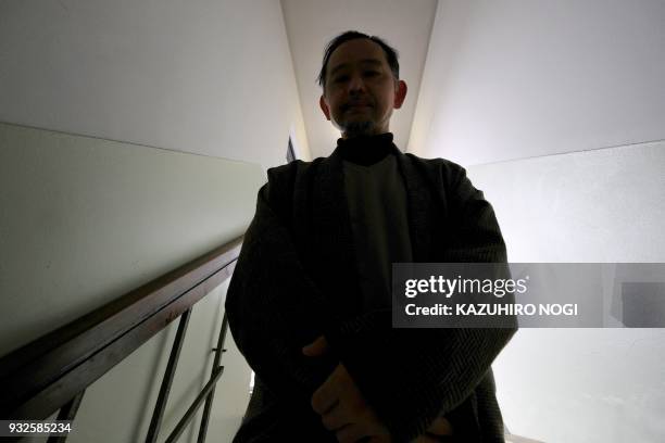This picture taken on March 8, 2018 shows Ikeida, a 55-year Japanese man who has chosen to shut himself completely away from society, posing for a...