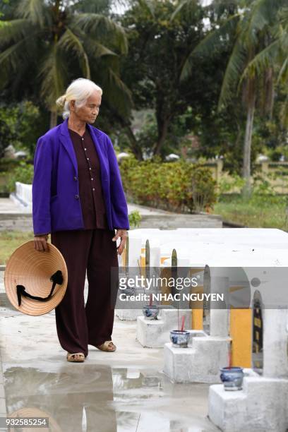 Pham Thi Thuan a survivor of the My Lai massacre, visits the mass grave in Son My village in Quang Ngai province on March 15, 2018. The massacre,...