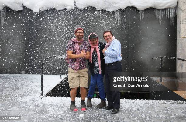 Director Andy Morton, Set and Costume Designer Dan Potra, and Artistic Director Lyndon Terracini pose as fake snow is being thrown onto the set...