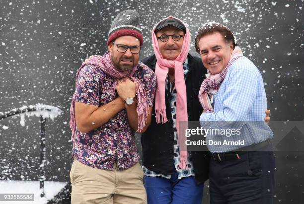 Director Andy Morton, Set and Costume Designer Dan Potra, and Artistic Director Lyndon Terracini pose as fake snow is being thrown onto the set...