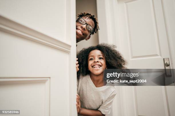 playful siblings - kid hide and seek stock pictures, royalty-free photos & images