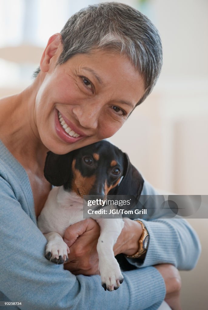 Chinese woman holding dachshund