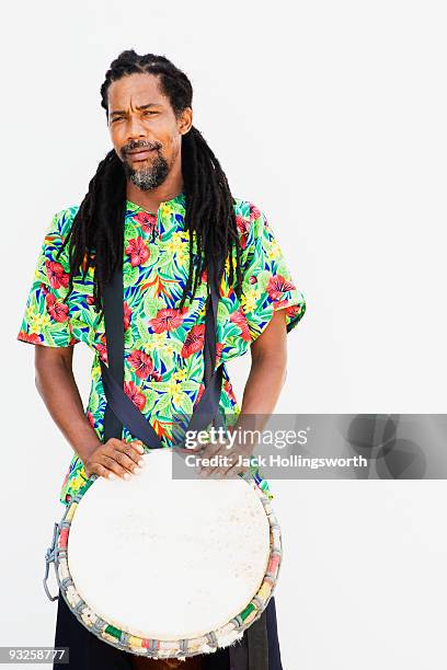 african man holding drum - caribbean musical instrument stock pictures, royalty-free photos & images