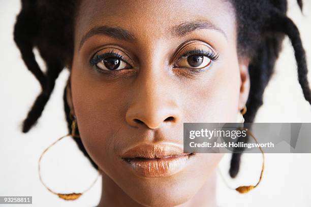 close up of serious african woman - anxious looking to camera fotografías e imágenes de stock