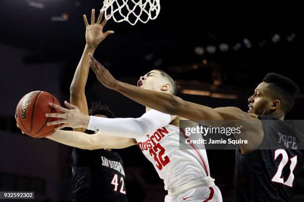 Rob Gray of the Houston Cougars attempts a shot defended by Jeremy Hemsley and Malik Pope of the San Diego State Aztecs during the second half of the...