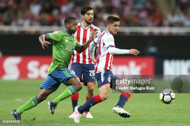 Isaac Brizuela of Chivas fights for the ball with Jordan McCrary of Seattle Sounders during the quarterfinals second leg match between Chivas and...