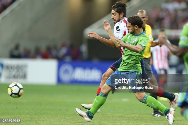 Rodolfo Pizarro of Chivas fights for the ball with Cristian Roldan of Seattle Sounders during the quarterfinals second leg match between Chivas and...