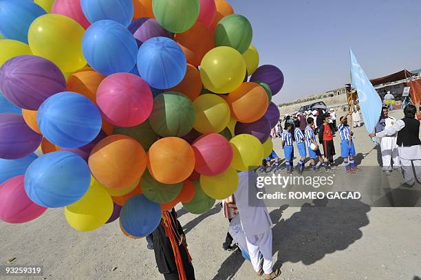 Colourful balloons are prepared for release as Afghan football team parade with a flag with an inscription "peace for all" during a peace festival at...