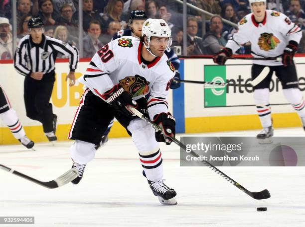 Brandon Saad of the Chicago Blackhawks plays the puck down the ice during first period action against the Winnipeg Jets at the Bell MTS Place on...