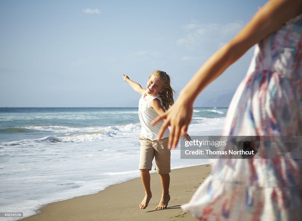 Two girls playing at the beach.