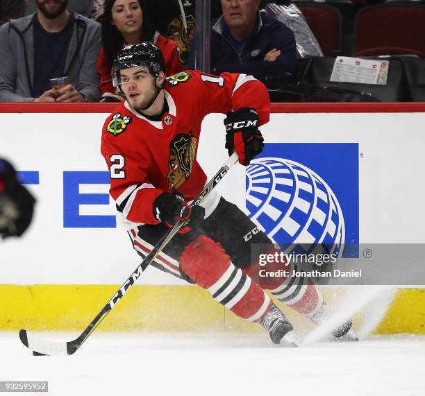 Alex DeBrincat of the Chicago Blackhawks controls the puck against the Calgary Flames at the United Center on February 6 2018 in Chicago, Illinois....