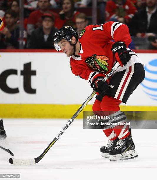 Alex DeBrincat of the Chicago Blackhawks controls the puck against the Calgary Flames at the United Center on February 6 2018 in Chicago, Illinois....