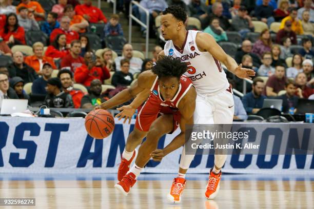 Collin Sexton of the Alabama Crimson Tide drives to the basket against Justin Robinson of the Virginia Tech Hokies during the first half of the game...