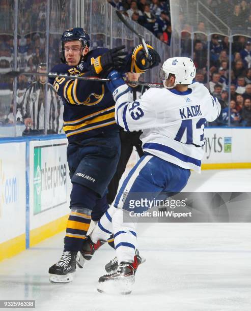 Rasmus Ristolainen of the Buffalo Sabres and Nazem Kadri of the Toronto Maple Leafs collide during an NHL game on March 15, 2018 at KeyBank Center in...