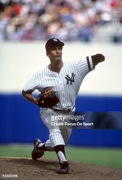 S: Pitcher Tommy John of the New York Yankees winds up to pitch during a circa 1980's Major League Baseball game at Yankee Stadium in Bronx, New...