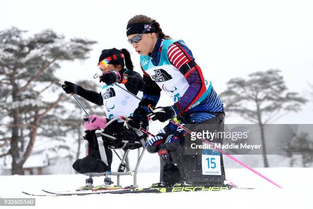 Oksana Masters of the United States, right, and Akzhana Abdikarimova of Neutral Paralympic Athlete compete in the Women's 12.5 km Sitting Biathlon at...