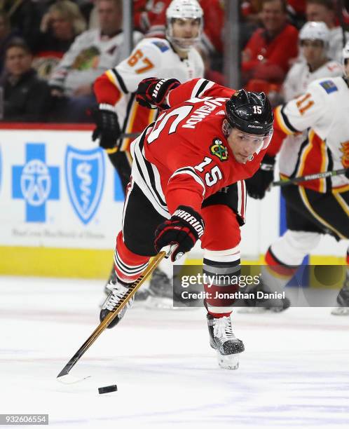 Artem Anisimov of the Chicago Blackhawks reaches for the puck against the Calgary Flames at the United Center on February 6 2018 in Chicago,...