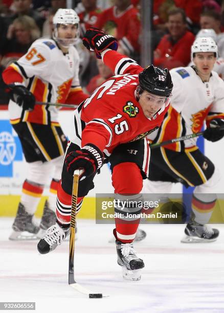 Artem Anisimov of the Chicago Blackhawks reaches for the puck against the Calgary Flames at the United Center on February 6 2018 in Chicago,...