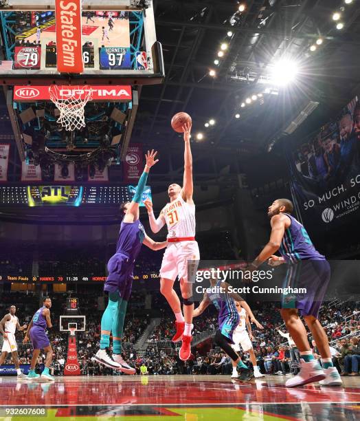 Mike Muscala of the Atlanta Hawks dunks against the Charlotte Hornets on March 15, 2018 at Philips Arena in Atlanta, Georgia. NOTE TO USER: User...