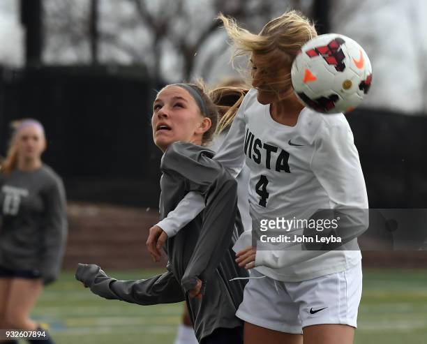Moutain Vista Savannah Mills heads the ball away as Columbine Melaini Jamison looks on during their soccer game on March 15, 2018 at Shea Stadium in...
