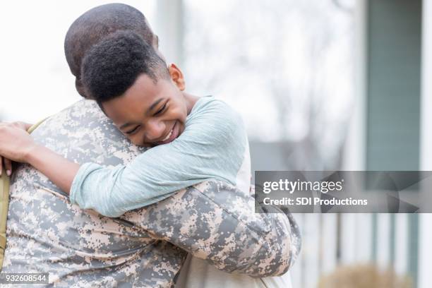 boy is happy his dad is home from deployment - homecoming stock pictures, royalty-free photos & images