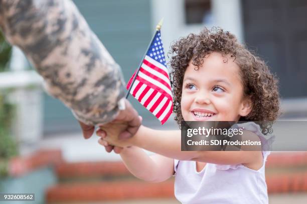 adorable little girl holds her military dad's hand - cute girl hairstyles family stock pictures, royalty-free photos & images