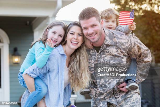 happy soldier home from deployment - husband and wife portrait stock pictures, royalty-free photos & images