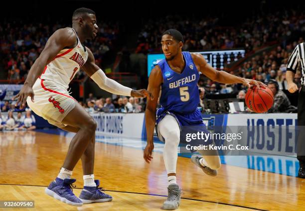 Massinburg of the Buffalo Bulls handles the ball against Rawle Alkins of the Arizona Wildcats in the first half during the first round of the 2018...