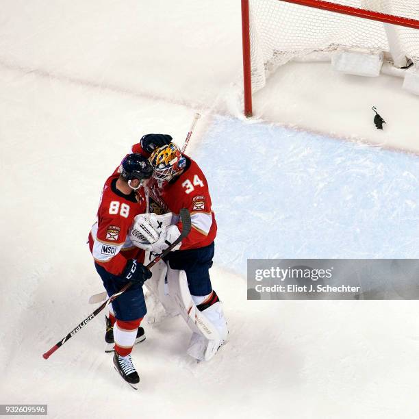 Goaltender James Reimer of the Florida Panthers celebrates with teammate Jamie McGinn their shut out 3-0 win over the Boston Bruins at the BB&T...