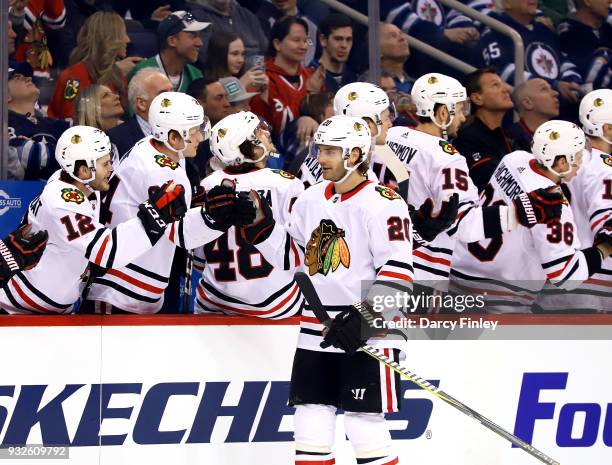 Brandon Saad of the Chicago Blackhawks celebrates his first period goal against the Winnipeg Jets with teammates at the bench at the Bell MTS Place...