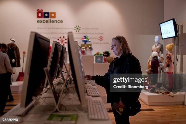 Crystal Premo looks over auction items on an Apple Inc. IMac computer at the eBay @ 57th Pop-up Marketplace store in New York, U.S., on Friday, Nov....