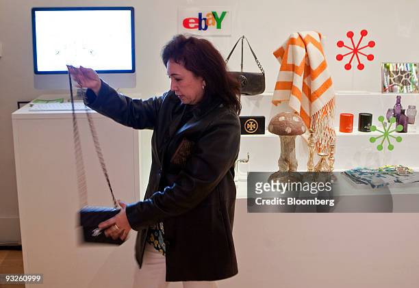 Zeny Gopez, who has never purchased an item off of eBay before, looks at a purse on display at the eBay @ 57th Pop-up Marketplace store in New York,...