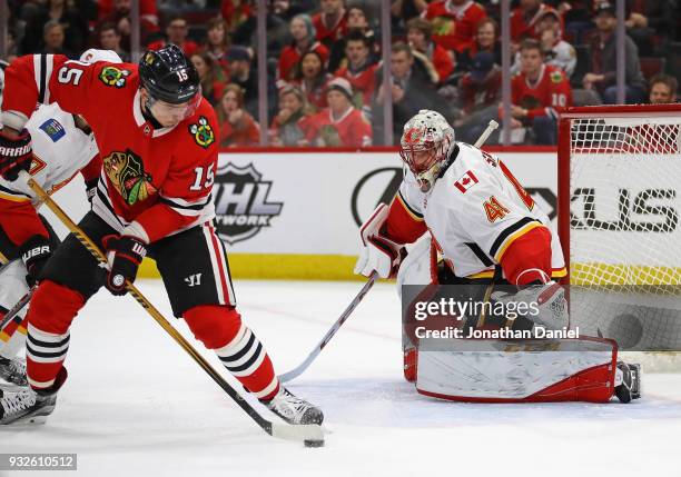 Mike Smith of the Calgary Flames looks at Artem Anisimov of the Chicago Blackhawks gets off a shot at the United Center on February 6 2018 in...