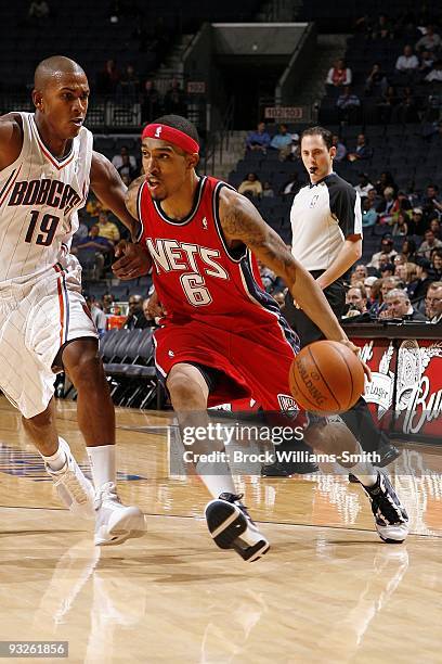 Courtney Lee of the New Jersey Nets drives to the basket against Raja Bell of the Charlotte Bobcats during the game at Time Warner Cable Arena on...