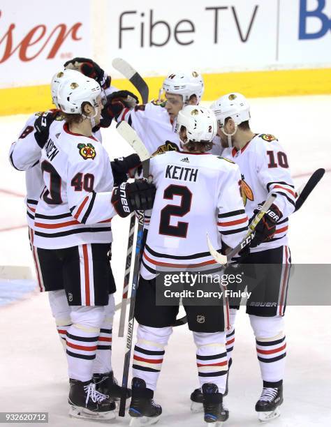 Nick Schmaltz, John Hayden, Duncan Keith, Jan Rutta and Patrick Sharp of the Chicago Blackhawks celebrate a second period goal against the Winnipeg...