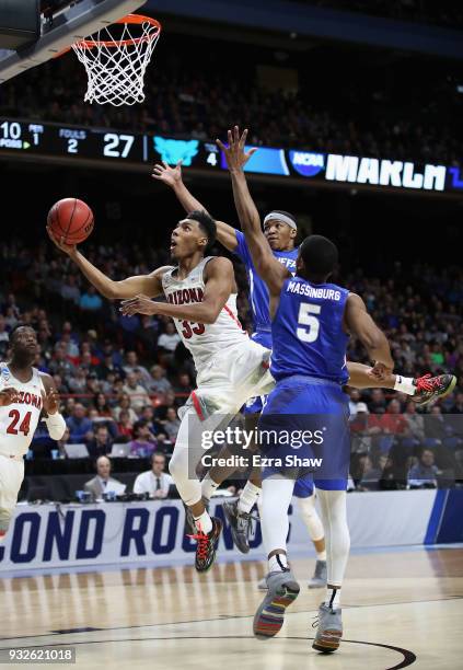 Allonzo Trier of the Arizona Wildcats drives to the basket against CJ Massinburg and Wes Clark of the Buffalo Bulls in the first half during the...