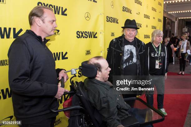 Neil Young walks the red carpet with sons Zeke and Ben and Warner Brothers publicist Rick Gershon during the SXSW Film premiere of "Paradox" on March...