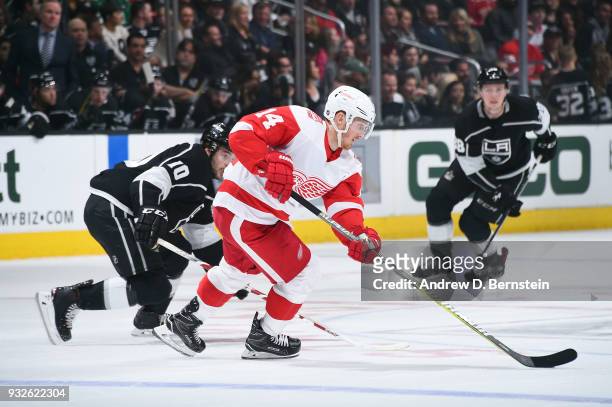 Gustav Nyquist of the Detroit Red Wings handles the puck against Tobias Rieder of the Los Angeles Kings at STAPLES Center on March 15, 2018 in Los...