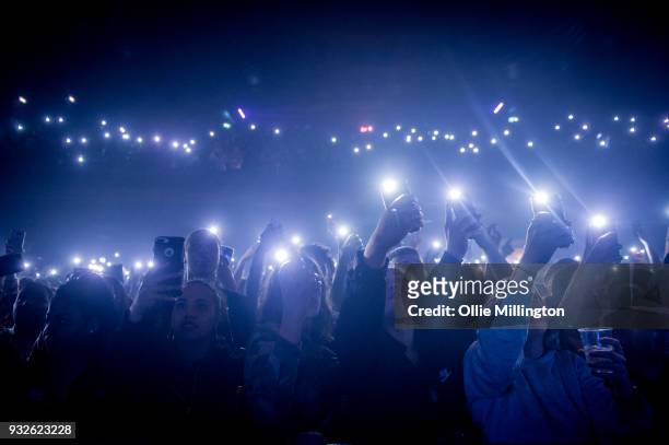 Music fans in the crowd watch on as MIST performs live on stage at O2 Forum Kentish Town on March 15, 2018 in London, England.