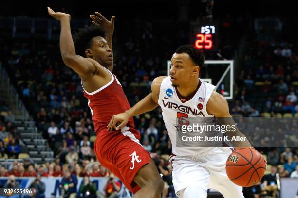 Justin Robinson of the Virginia Tech Hokies drives to the ball against Collin Sexton of the Alabama Crimson Tide late in the second half of the game...