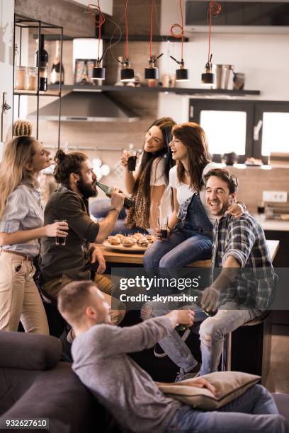 large group of happy friends talking on a home party. - house after party stock pictures, royalty-free photos & images