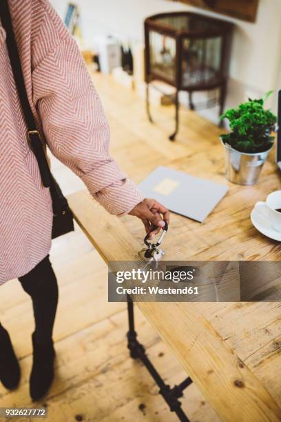 woman coming home, putting keys on table - returning keys stock pictures, royalty-free photos & images