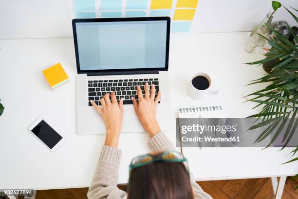 young woman working at desk with laptop - sticky-notes-covering-computer-monitor stock pictures, royalty-free photos & images