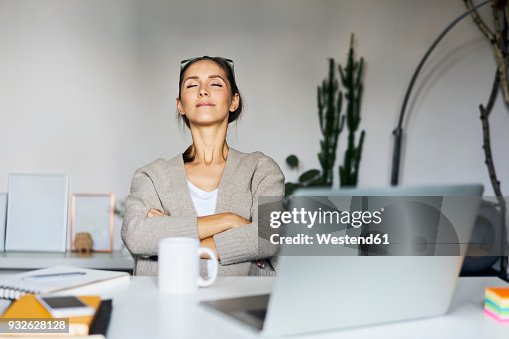 Young woman at home with laptop on desk having a break Young woman at home with laptop on desk having a break