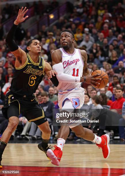 David Nwaba of the Chicago Bulls drives against Derrick Williams of the Los Angeles Lakers at the United Center on January 26, 2018 in Chicago,...