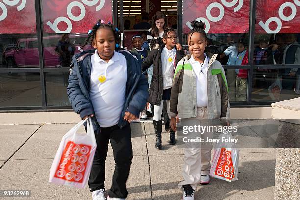 Children leaving the store with their new shoes at Payless ShoeSource on November 20, 2009 in Cincinnati, Ohio.