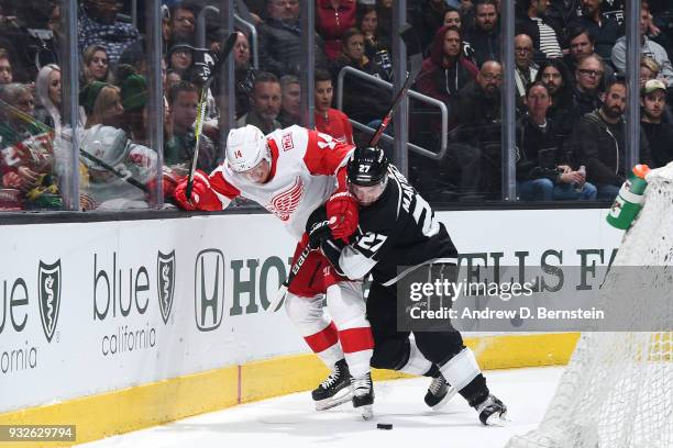 Alec Martinez of the Los Angeles Kings battles for the puck against Gustav Nyquist of the Detroit Red Wings at STAPLES Center on March 15, 2018 in...