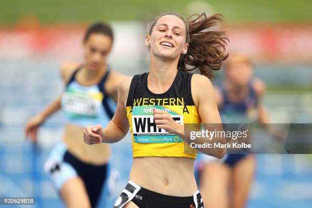 Sophie White of Western Australia celebrates victory in the Womens under 18 100 Metre Hurdles final during day three of the Australian Junior...