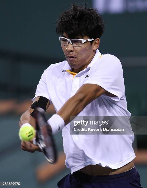 Hyeon Chung of Korea hits a backhand against Roger Federer Switzerland during Day 11 of BNP Paribas Open on March 15, 2018 in Indian Wells,...